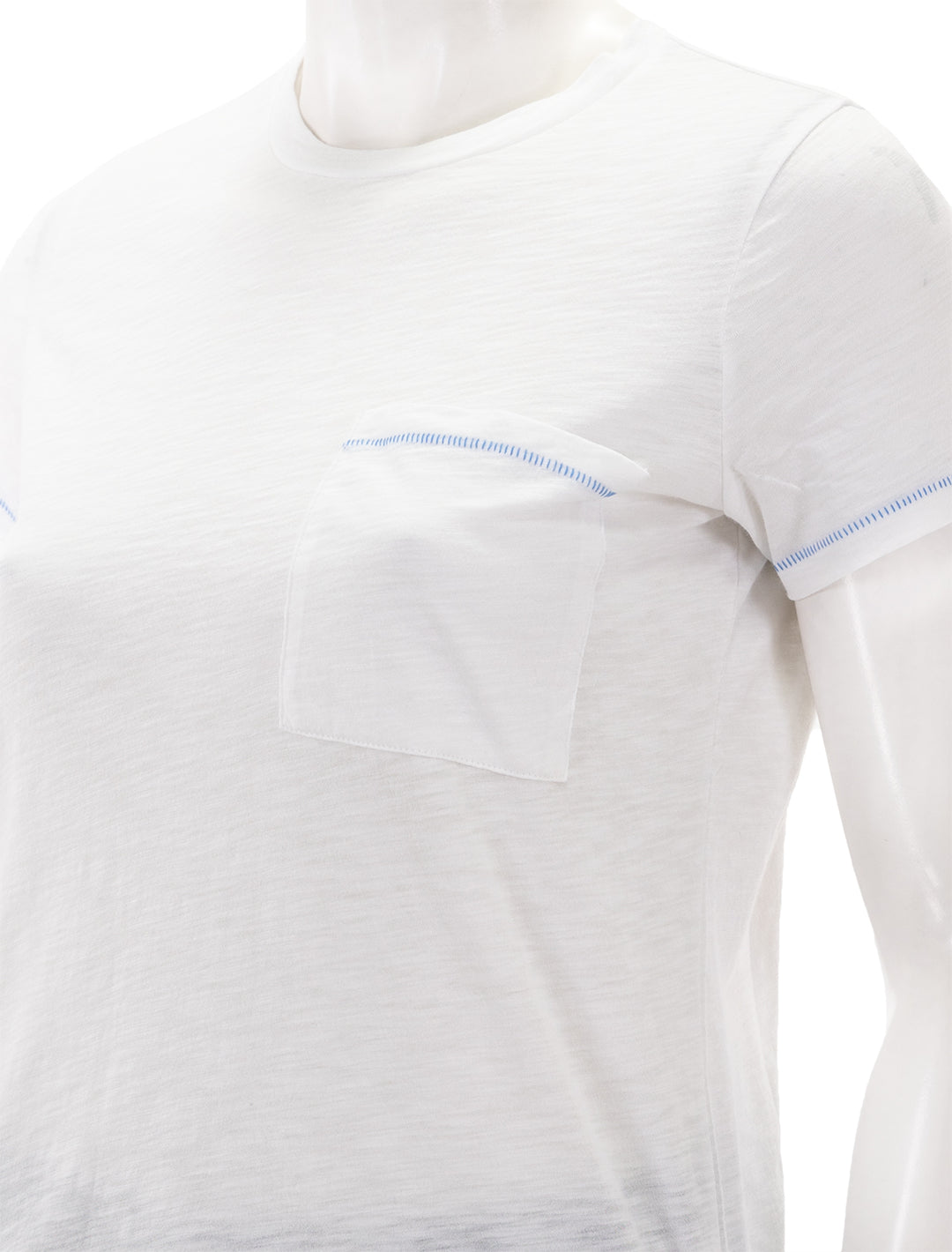 Close-up view of Goldie Lewinter's contrast stitch pocket boy tee.