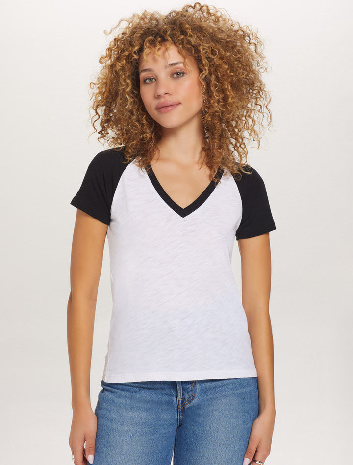 Model wearing Goldie Lewinter's short sleeved baseball tee in black.
