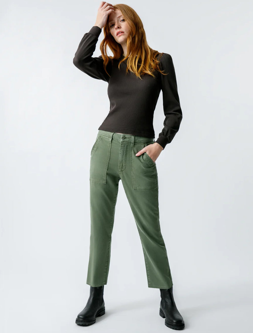 model wearing easy army trouser in tea leaf with a black top and boots