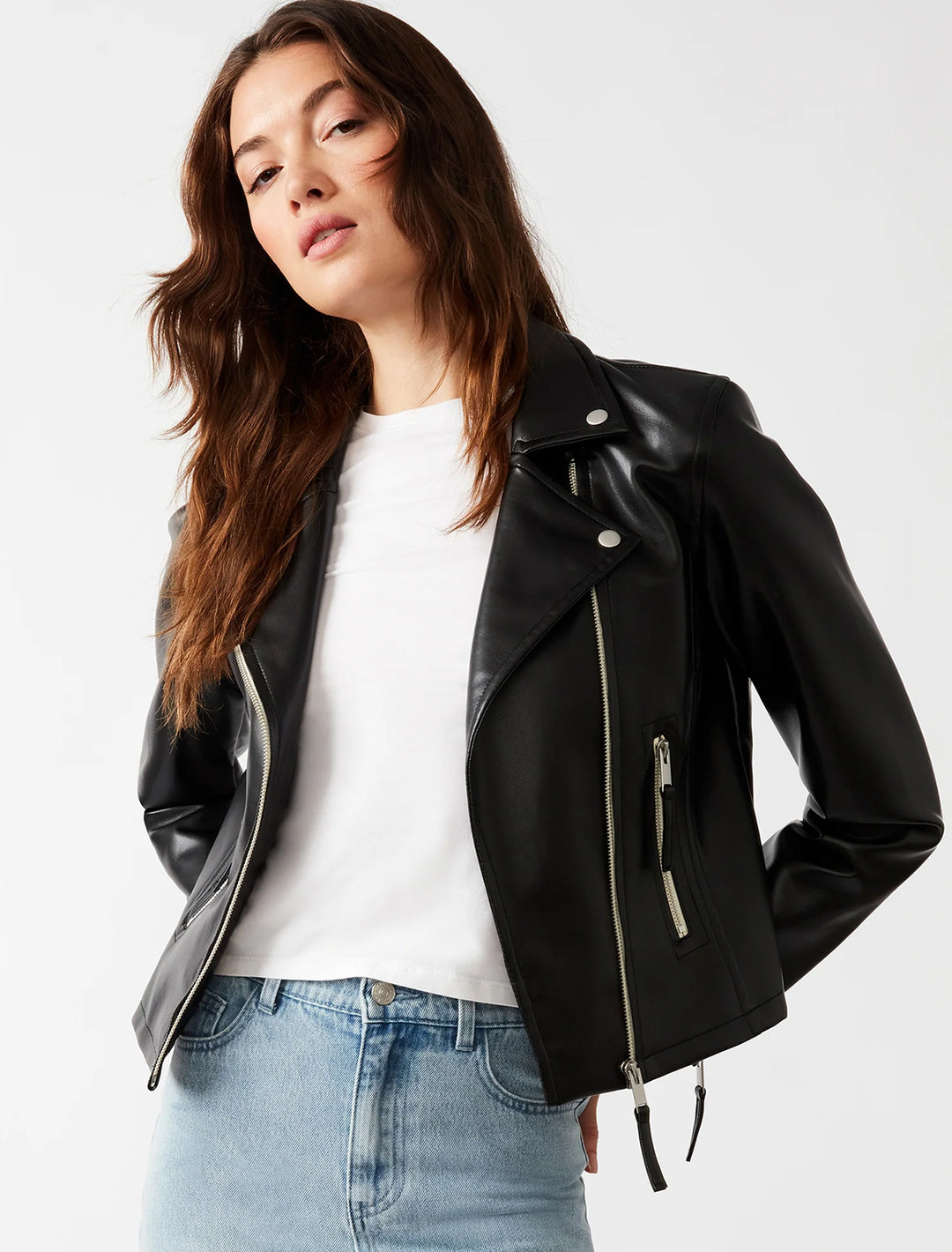 Model wearing Steve Madden's vinka jacket in black with a white tee and blue jeans.