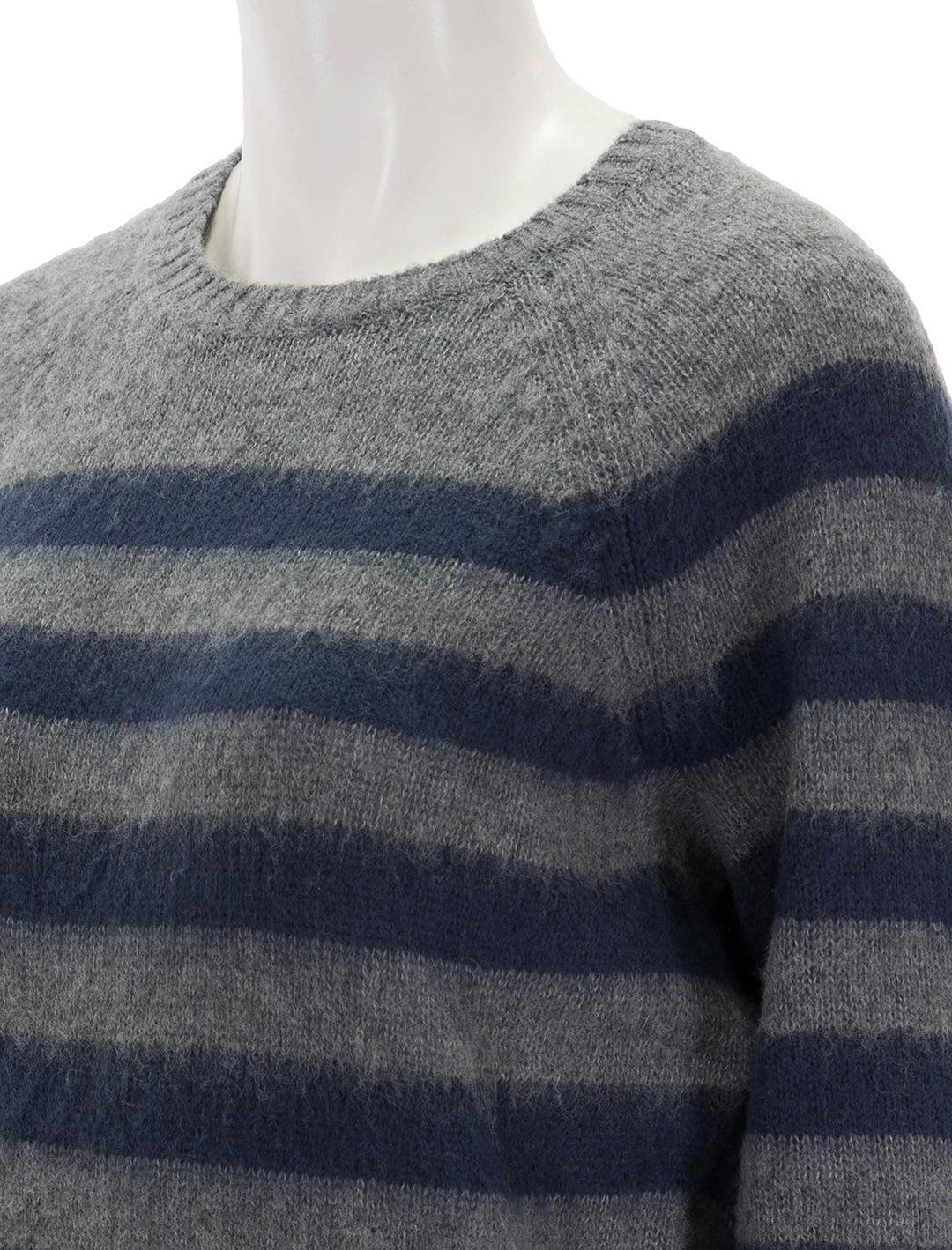 Close-up view of Steve Madden's lyon sweater in grey and navy stripe.