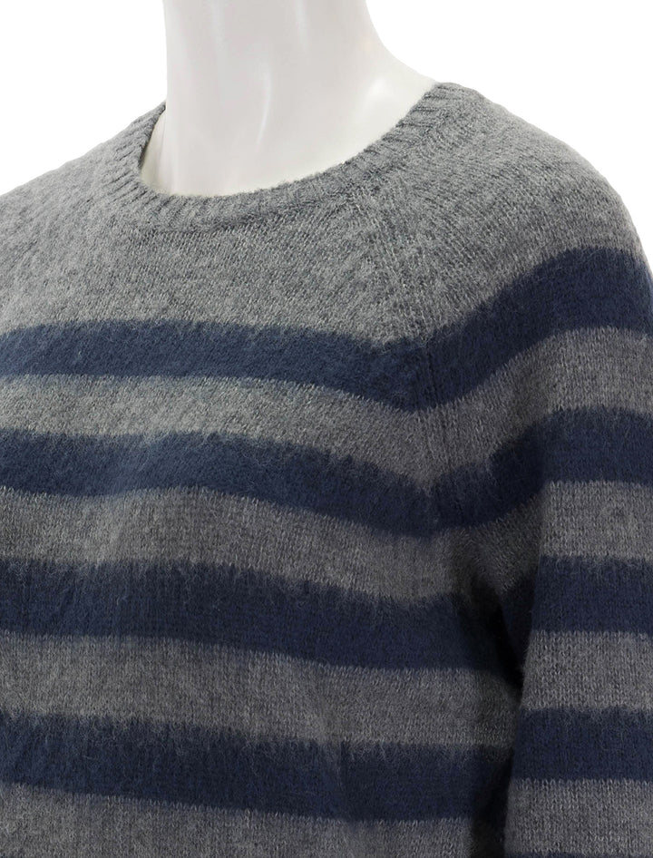 Close-up view of Steve Madden's lyon sweater in grey and navy stripe.