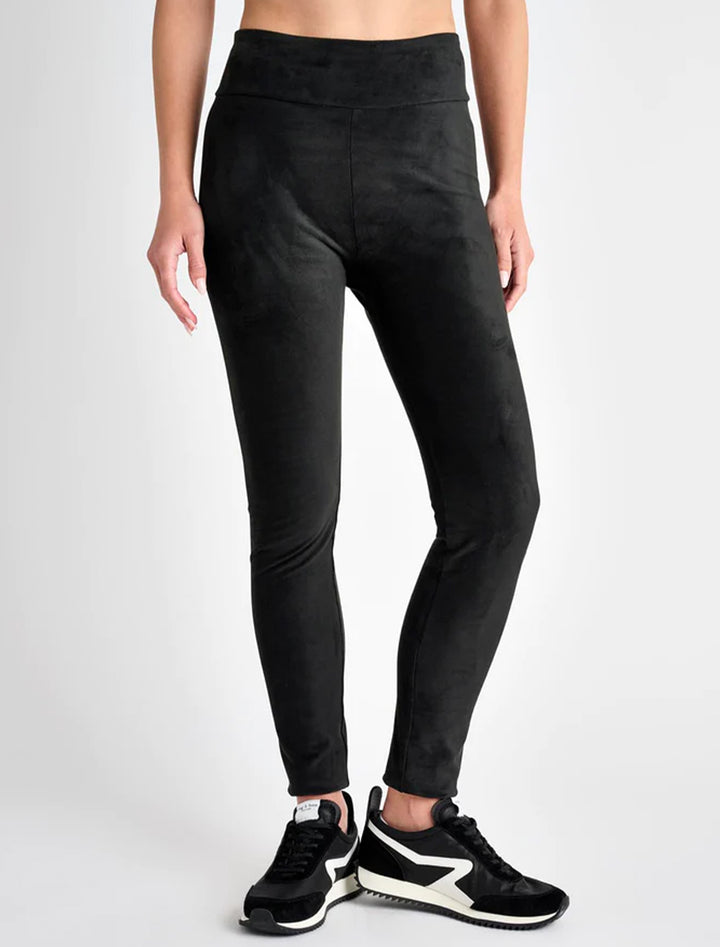 Model wearing Splendid's vegan suede leggings in black.