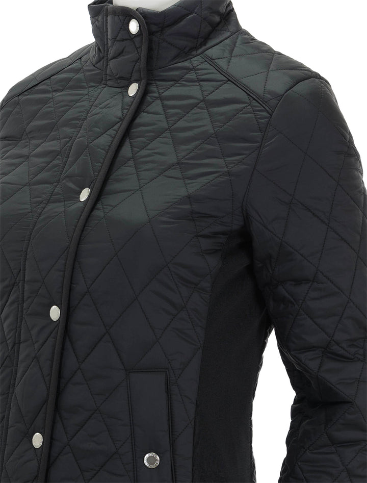 Close-up view of Barbour's yarrow quilted jacket in black.