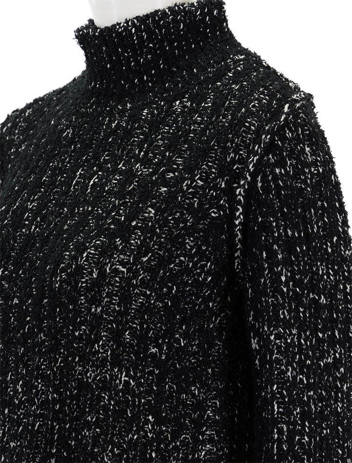 Close-up view of Steve Madden's Kirsten Sweater in Black Multi.