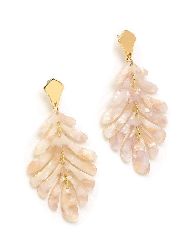 Stylized laydown of St. Armands' pink petite palm earrings.