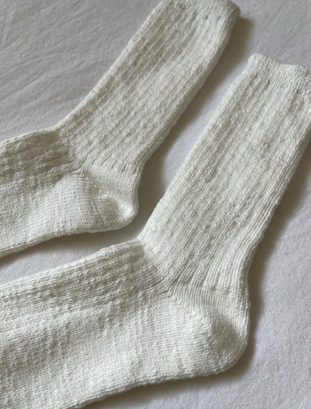 Close-up view of Le Bon Shoppe's cottage socks in white linen.