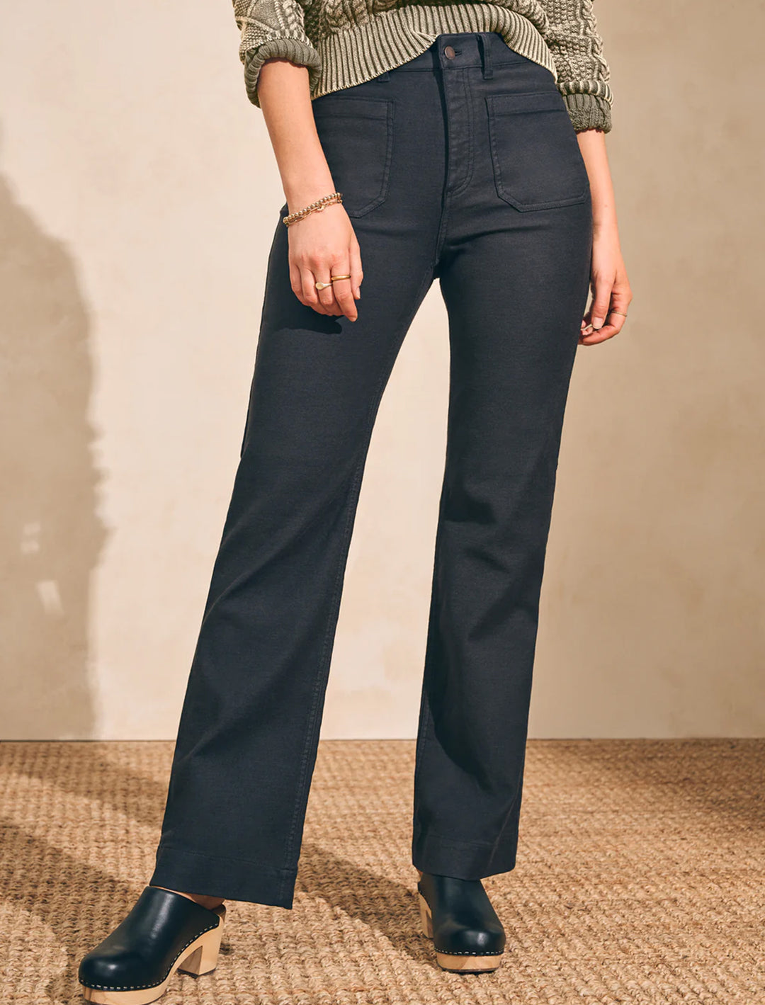 Model wearing Faherty's stretch terry patch pocket pant in washed black.