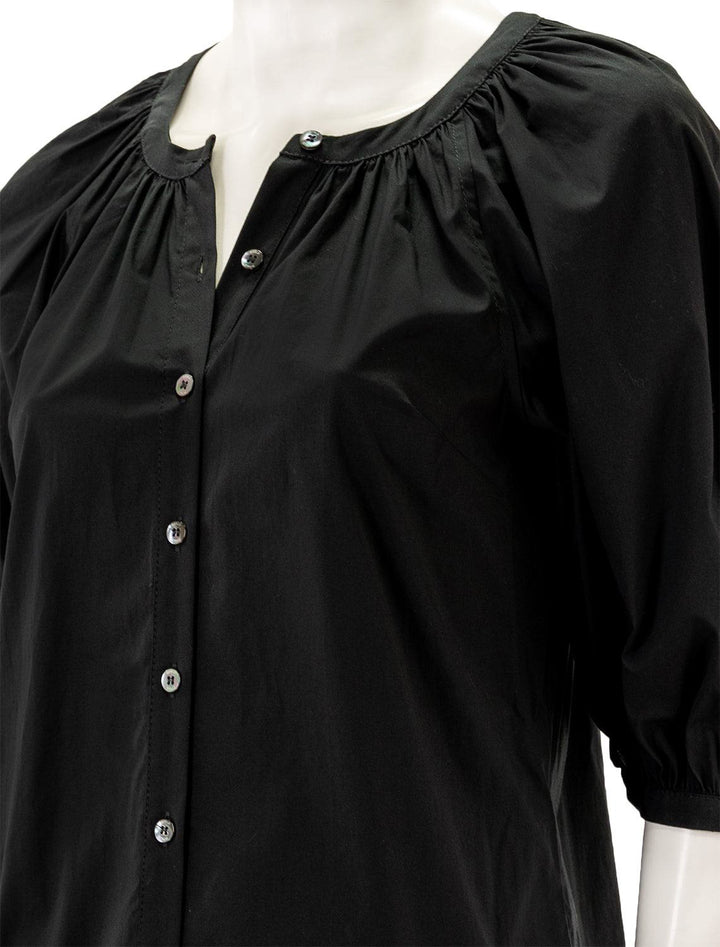 Close-up view of Staud's mini vincent dress in black.