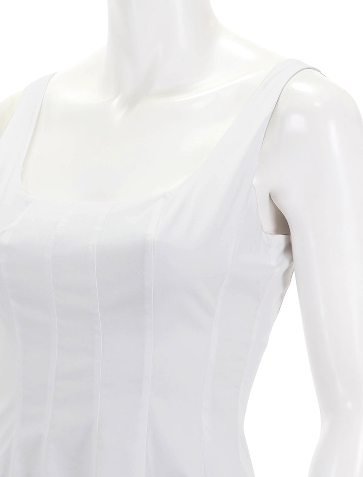 Close-up view of STAUD's mini wells dress in white.