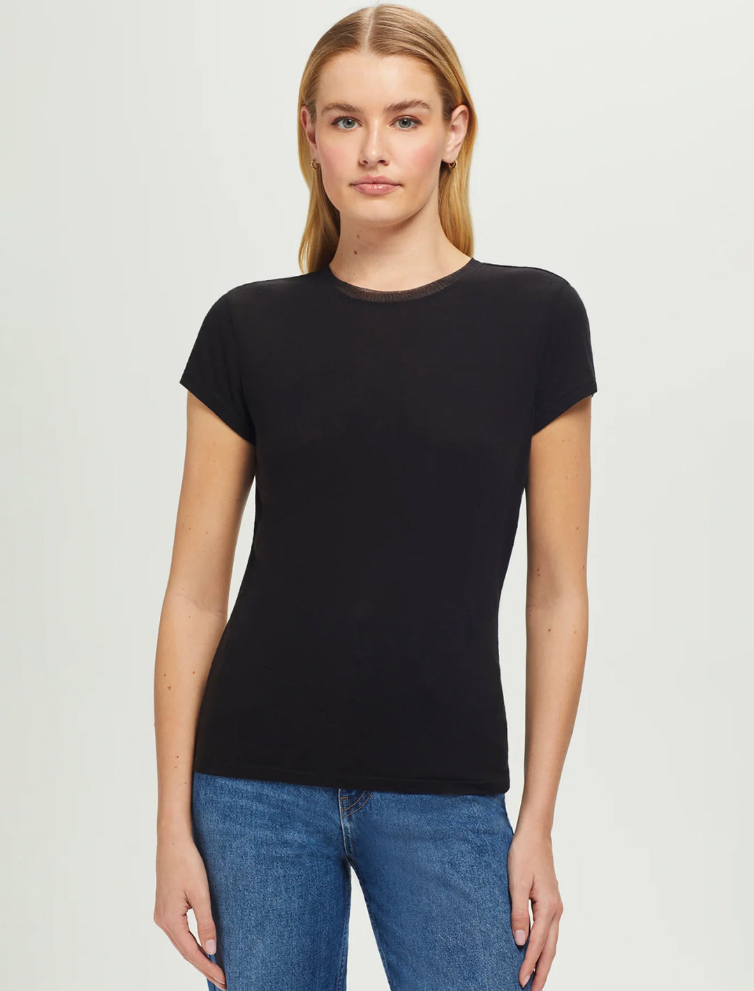 Model wearing Goldie Lewinter's short sleeve mesh trim tee in black.