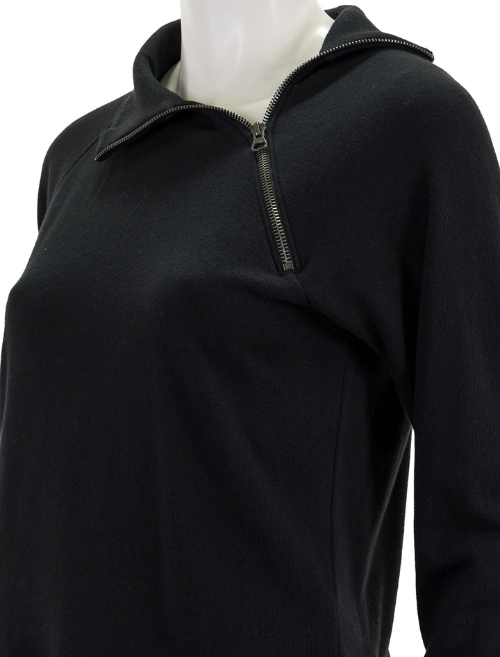 Close-up view of Goldie Lewinter's raglan zipneck sweatshirt in black.