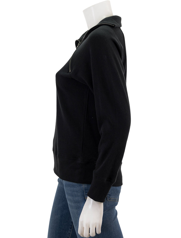 Side view of Goldie Lewinter's raglan zipneck sweatshirt in black.