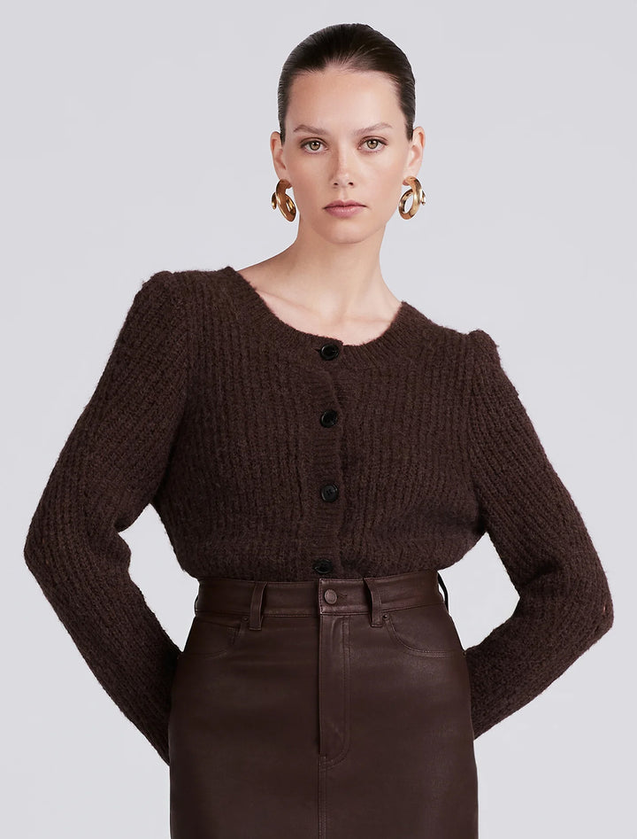 model wearing cosmo cardigan in chocolate with a matching leather skirt