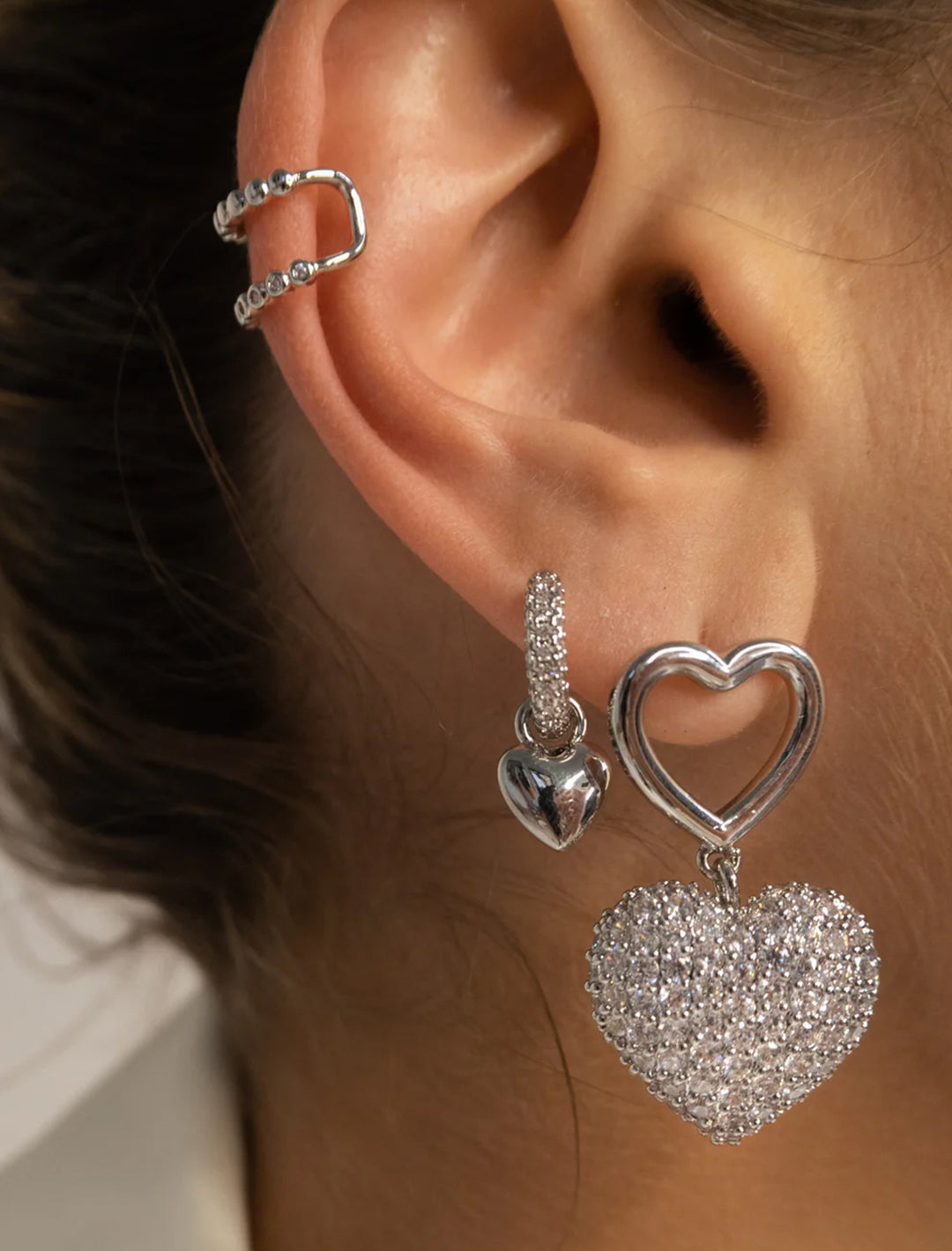 Model wearing Luv AJ's puffy heart silver huggies.
