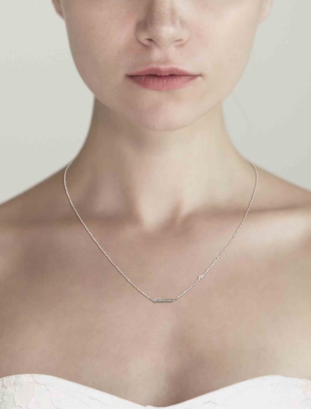 Model wearing Tai's horizontal bar necklace in silver with cz.