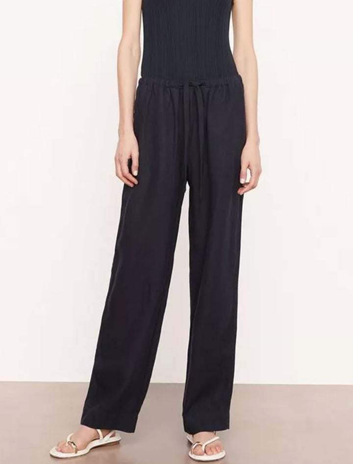 Model wearing Vince's mid waist tie front pull on pant in coastal.