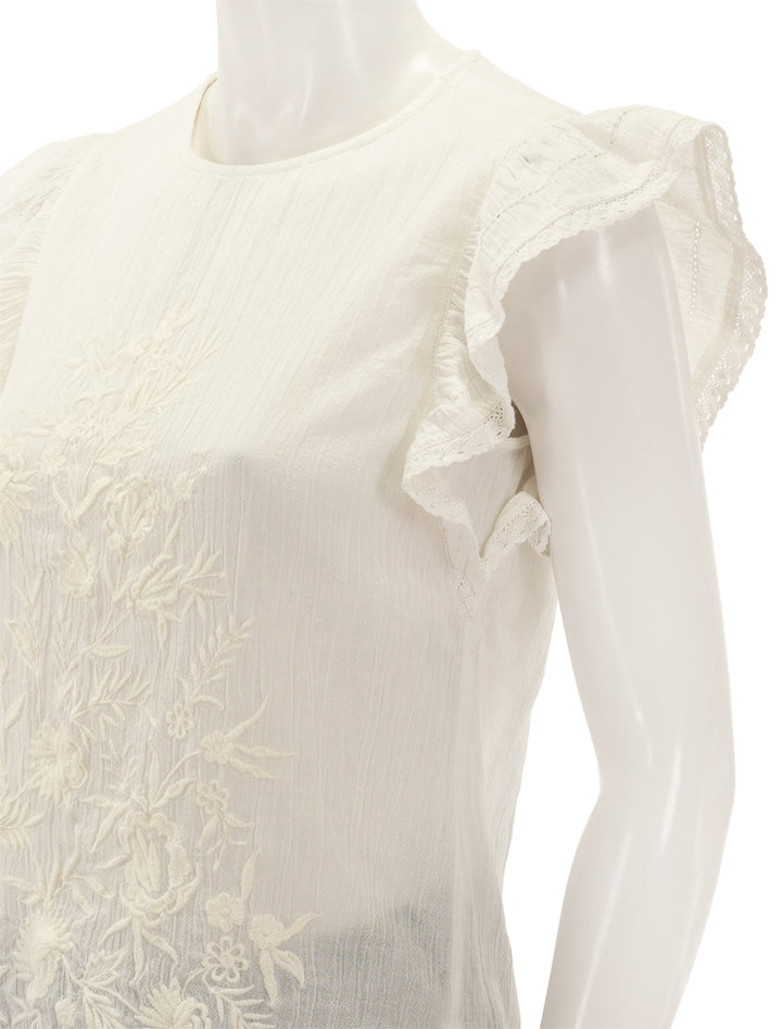 Close-up view of M.A.B.E.'s estella embroidered top in white.