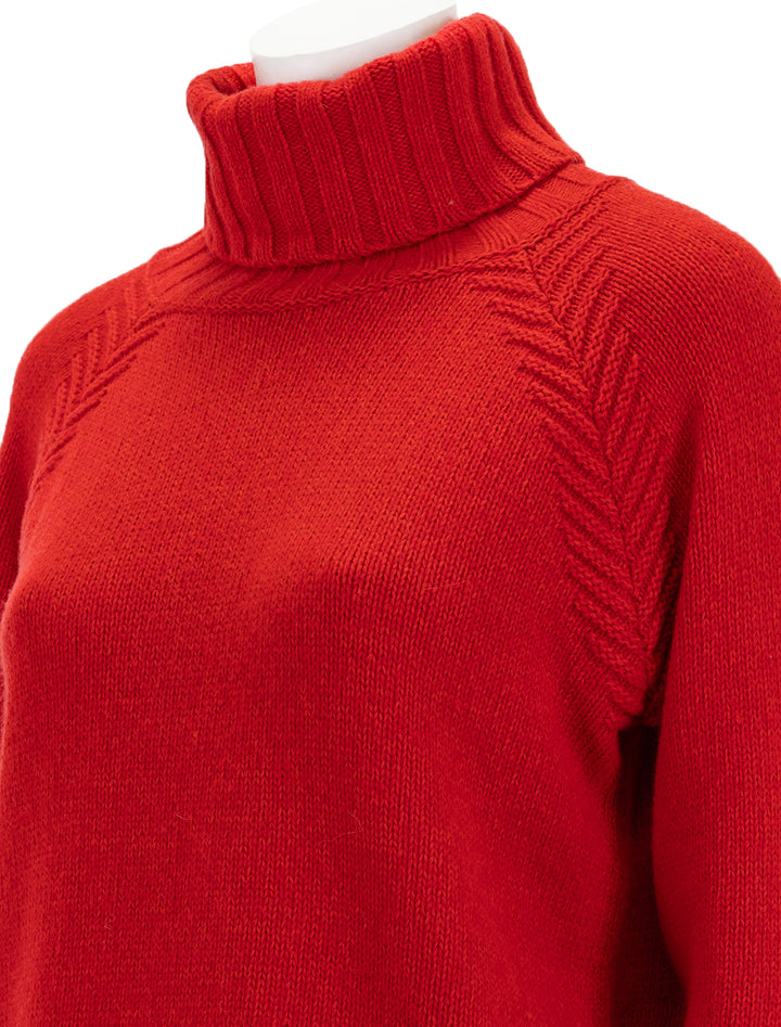 Close-up view of Barbour's norma turtleneck in blaze red.