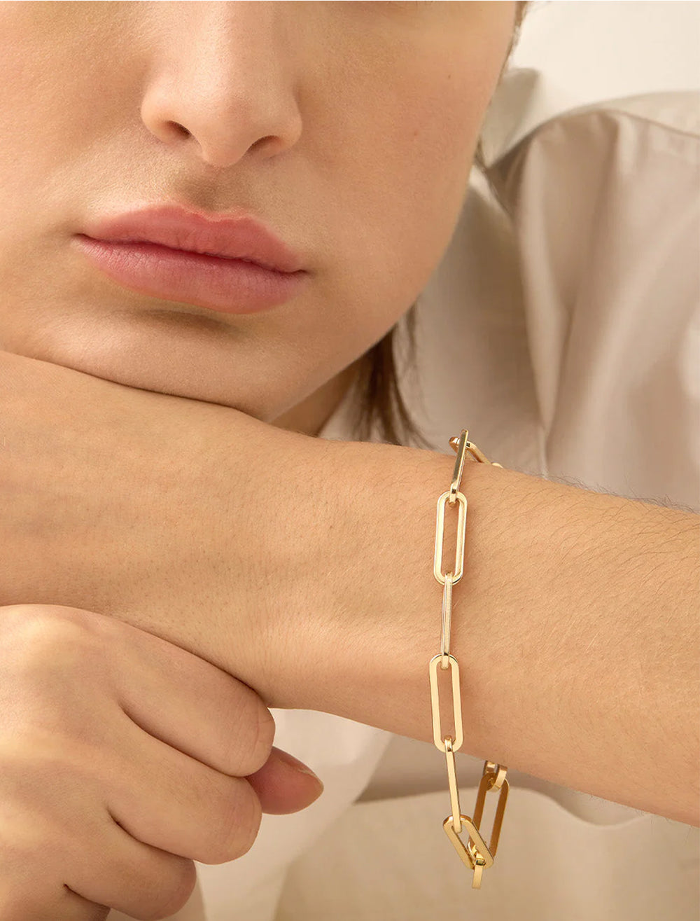 Model wearing Jenny Bird's andi slim bracelet in gold.