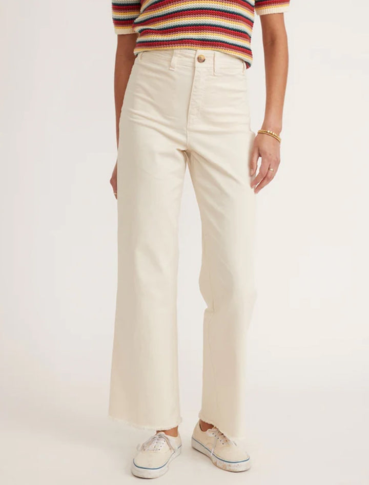 Model wearing Marine Layer's bridget pant in cream with raw hem.