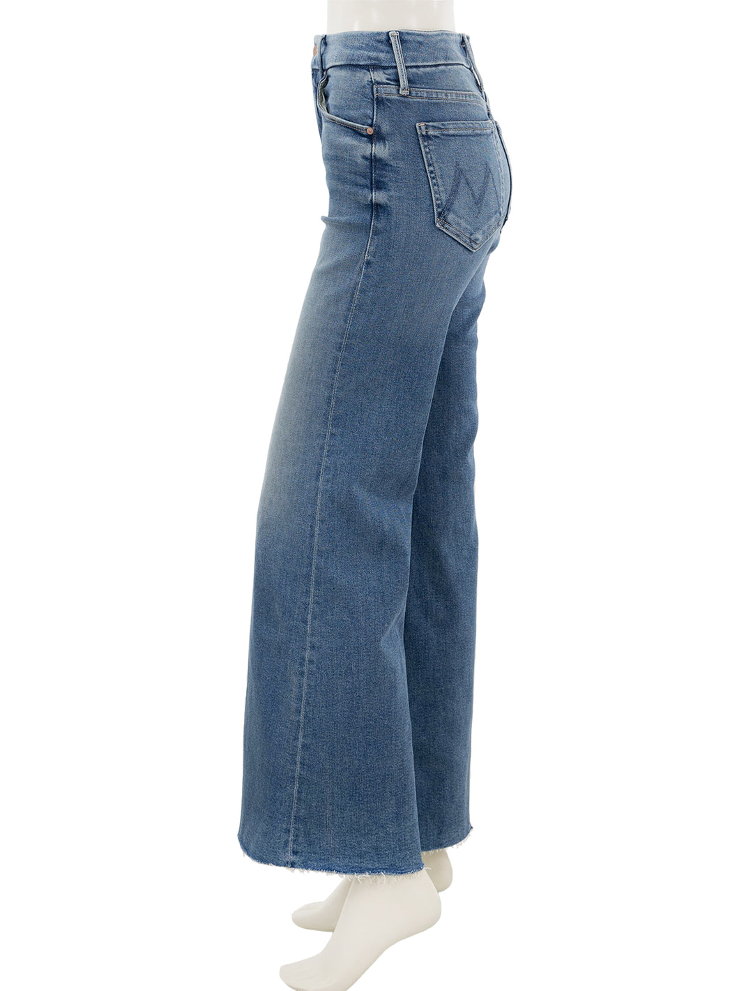 Side view of Mother Denim's the roller in riding the cliffside.