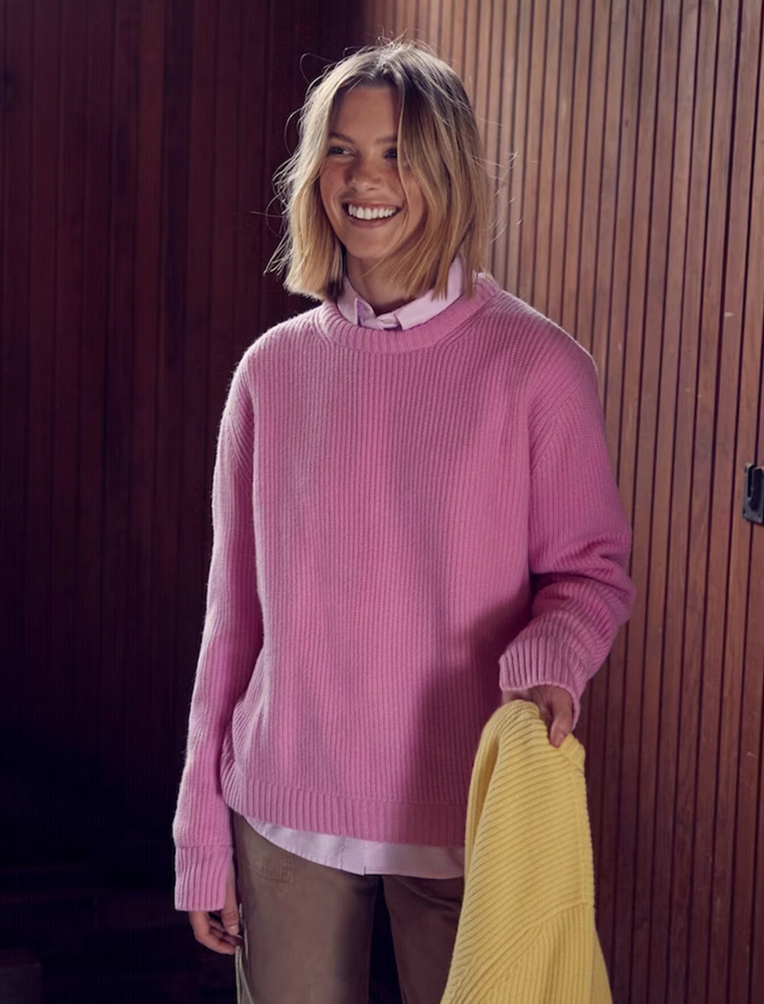 Model wearing KULE's the alden sweater in pink.