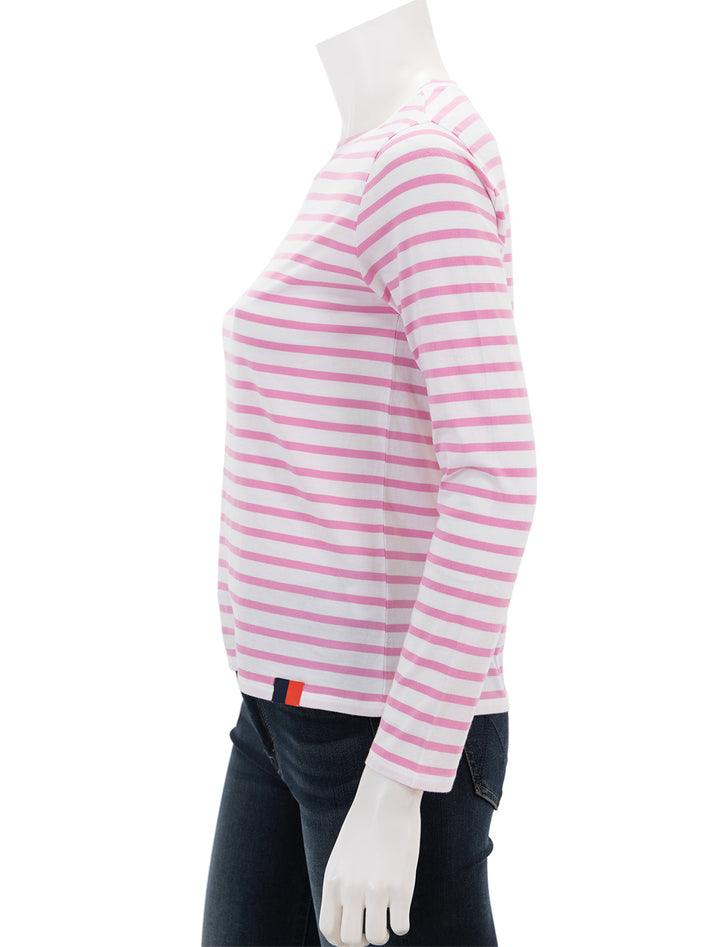 Side view of KULE's the modern long sleeve tee in pink and white stripe.