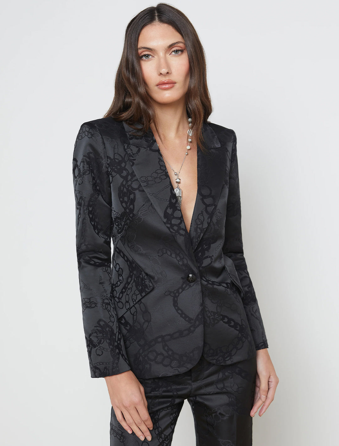Model wearing L'agence's chamberlin blazer in black multi chain.