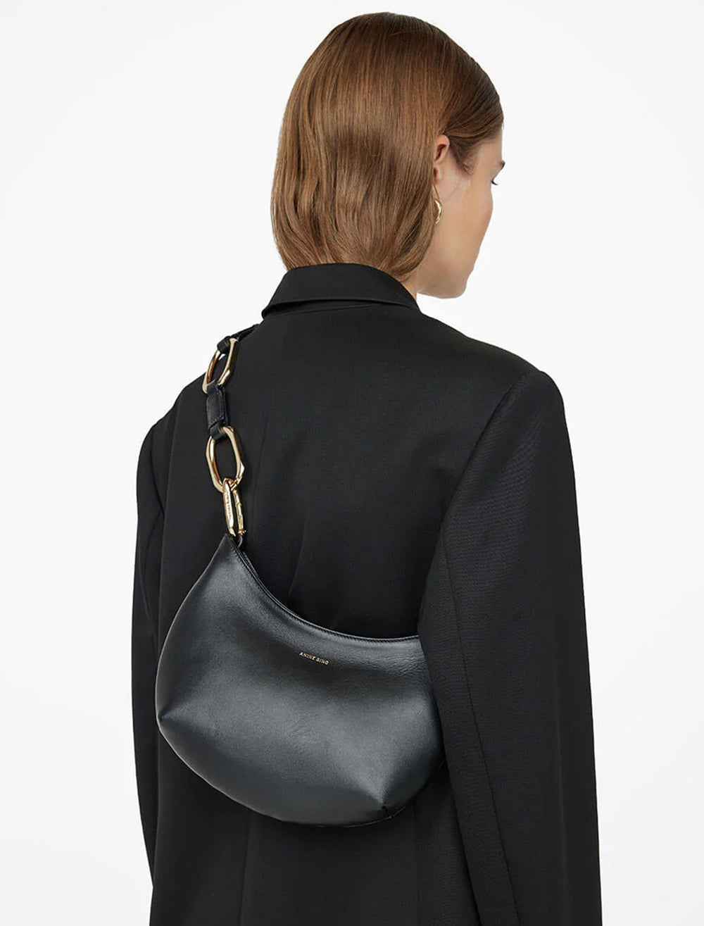 Model wearing Anine Bing's mini jody bag in black.