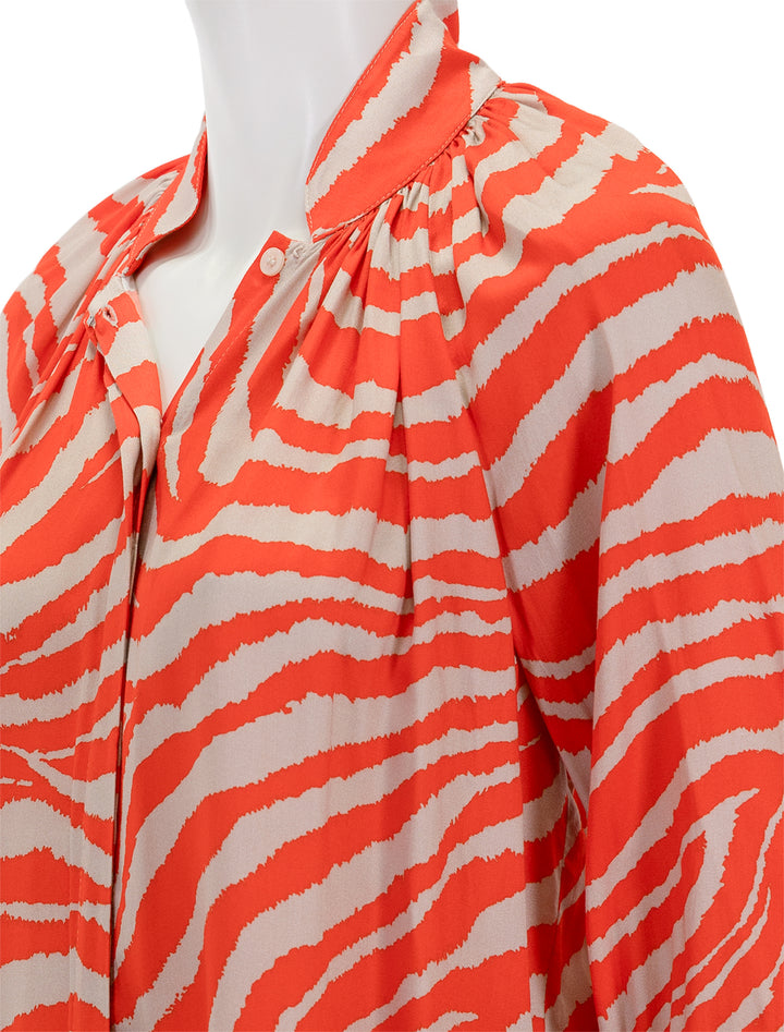 Close-up view of Smythe's gathered blouse in vermilion zebra.