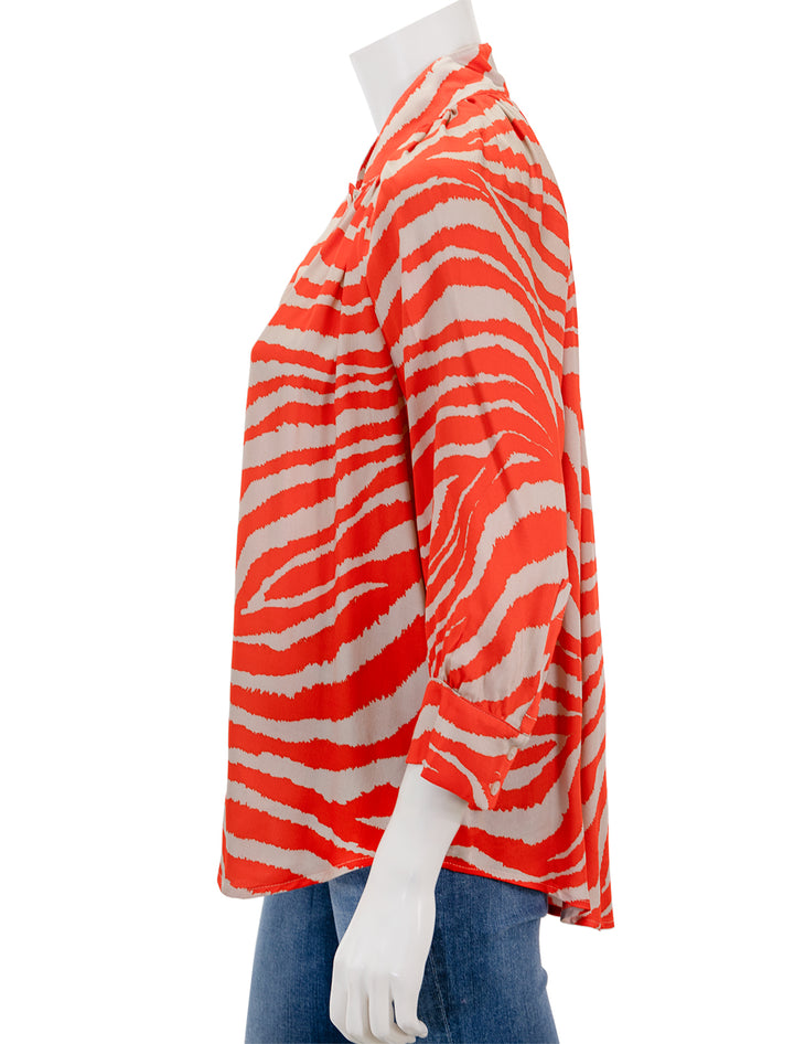 Side view of Smythe's gathered blouse in vermilion zebra.