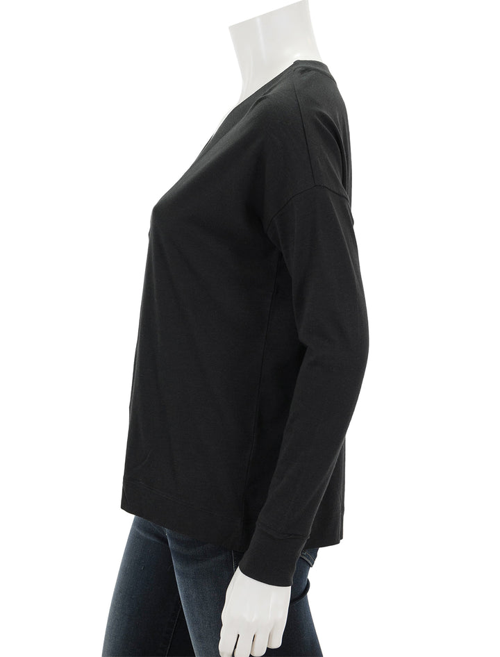 Side view of Lilla P.'s tapered trim v-neck in black.