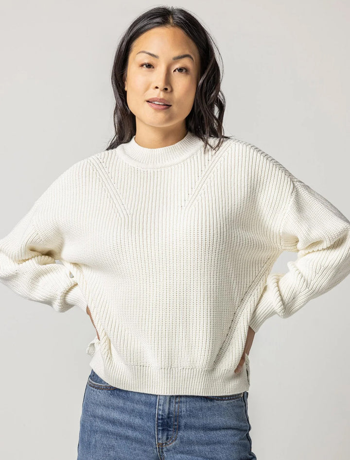 Model wearing Lilla P.'s oversized rib pullover sweater in ivory.