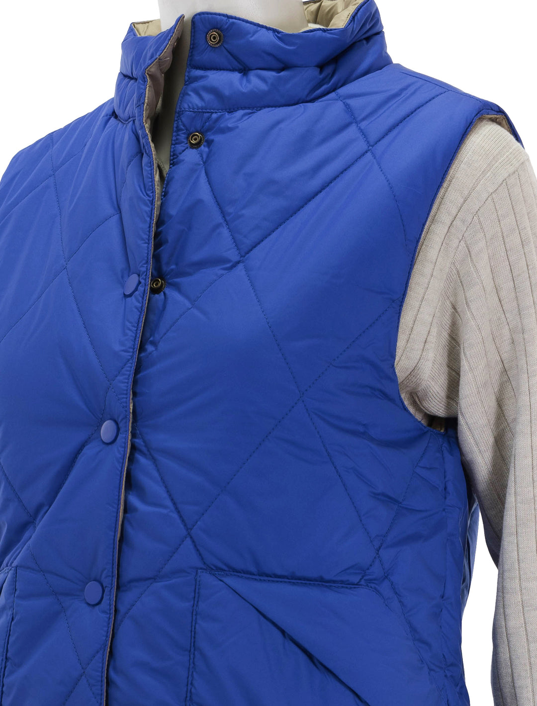 Close-up view of Lilla P.'s reversible snap front vest in sapphire.