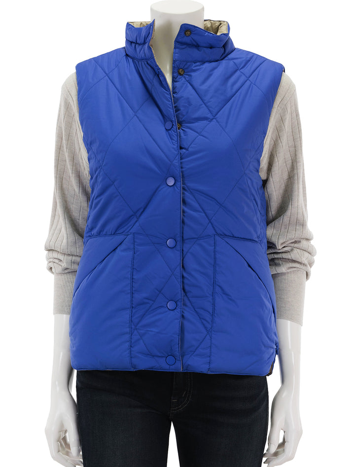 Front view of Lilla P.'s reversible snap front vest in sapphire, buttoned.