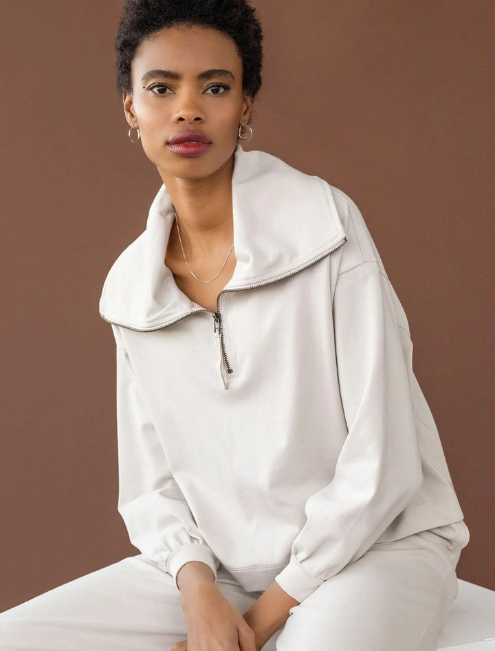 Model wearing Lilla P.'s full sleeve half zip pullover in alabaster.
