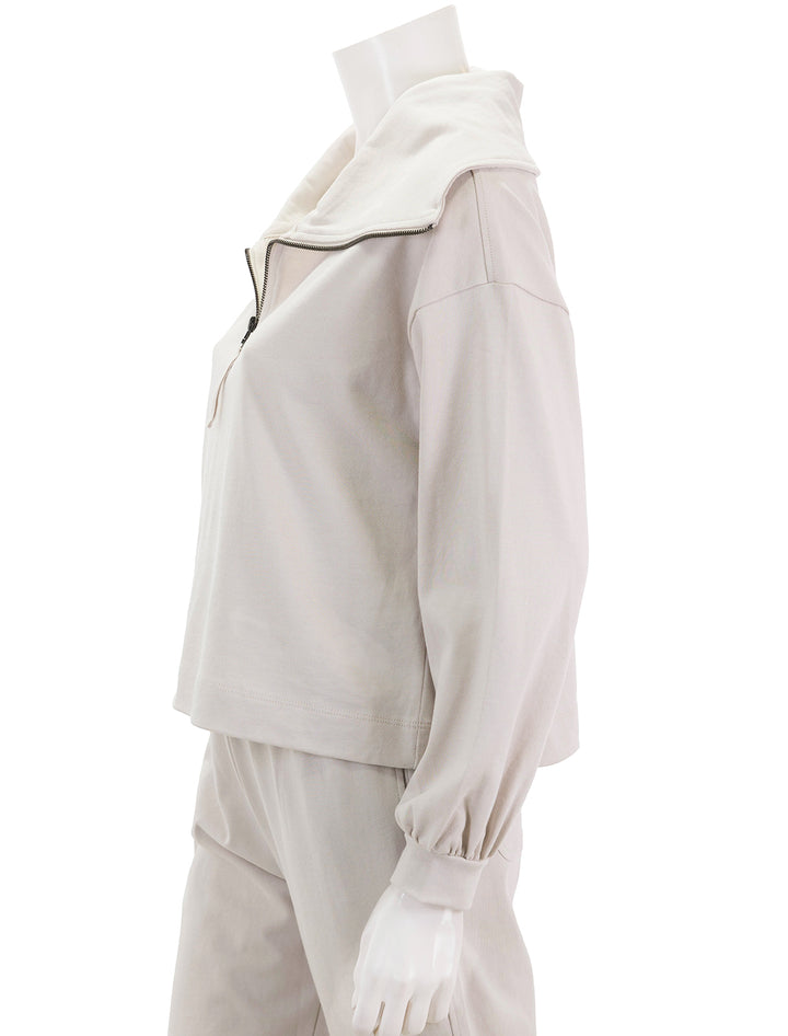 Side view of Lilla P.'s full sleeve half zip pullover in alabaster.