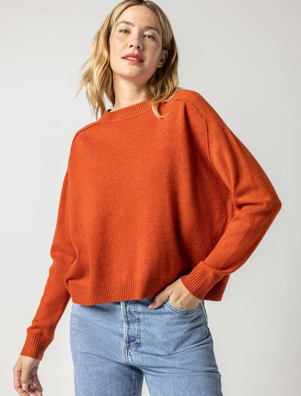 Model wearing Lilla P.'s oversized saddle sleeve sweater in spice.