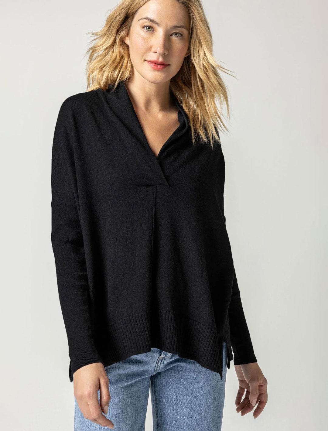 Model wearing Lilla P.'s oversized shawl collar sweater in black.
