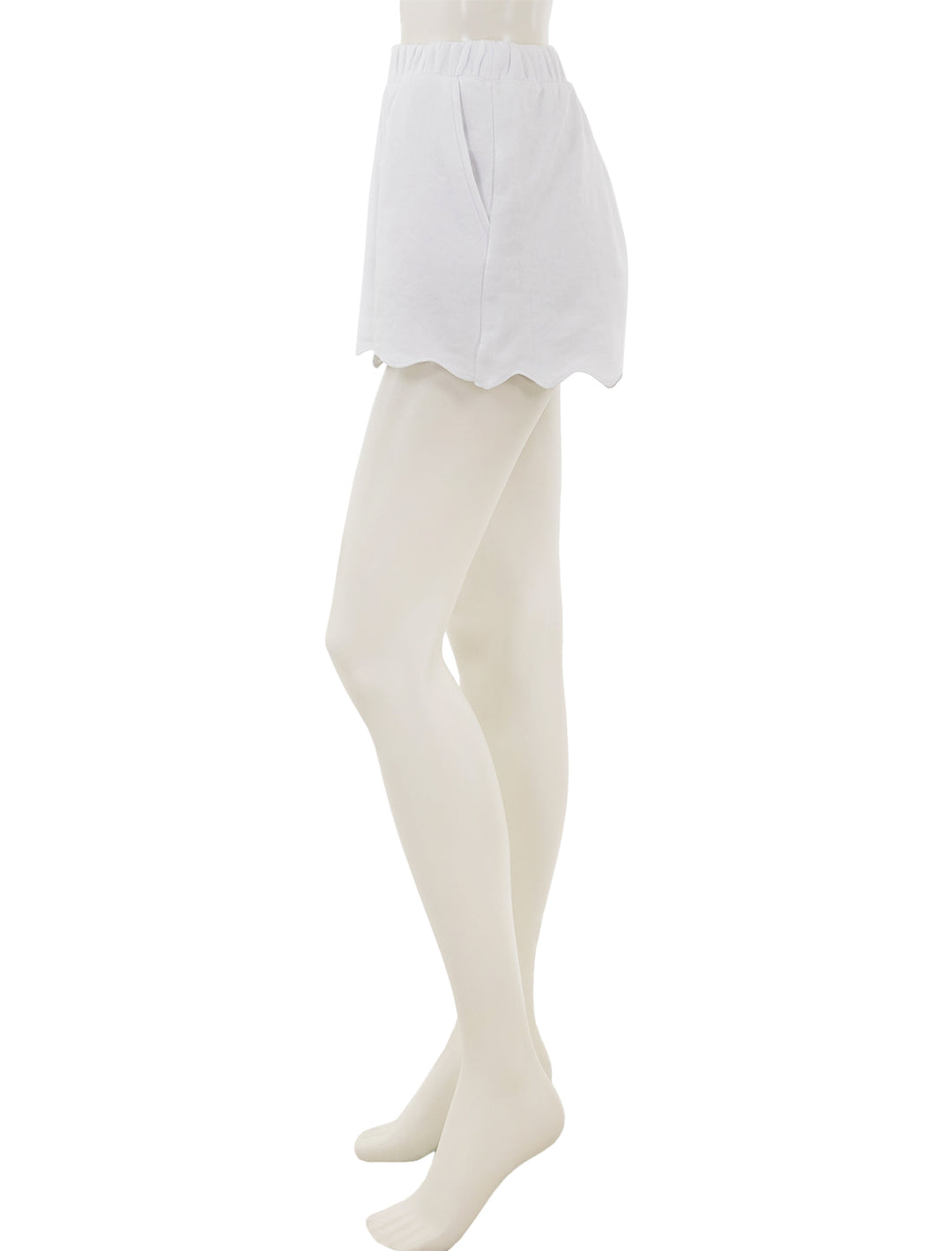 Side view of Splendid's nori scallop trim shorts in white.