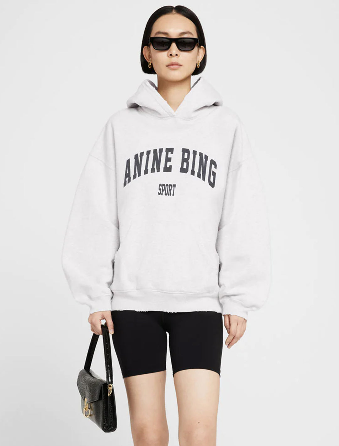 Model wearing Anine Bing's harvey sweatshirt in heather grey.