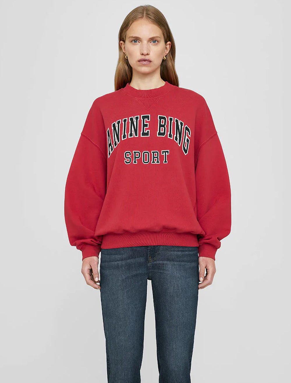 Model wearing Anine Bing's jaci sweatshirt in red.