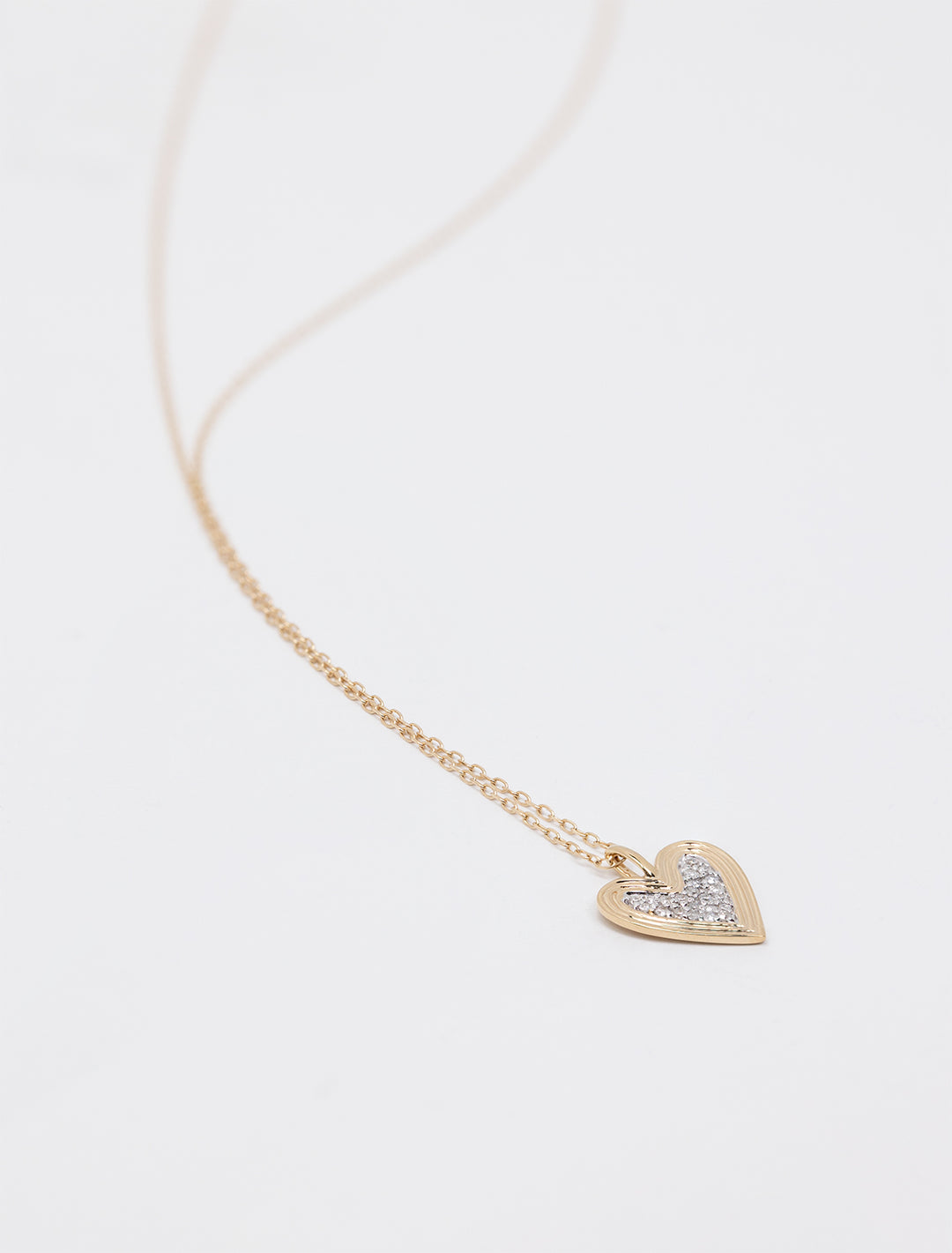 Laydown of Adina Reyter's 14k make your move pave heart necklace.