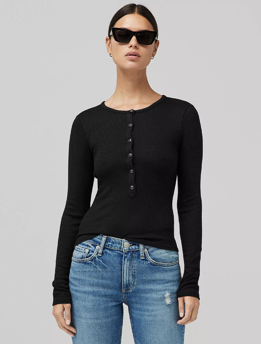 Model wearing Rag & Bone's the knit rib henley in black.