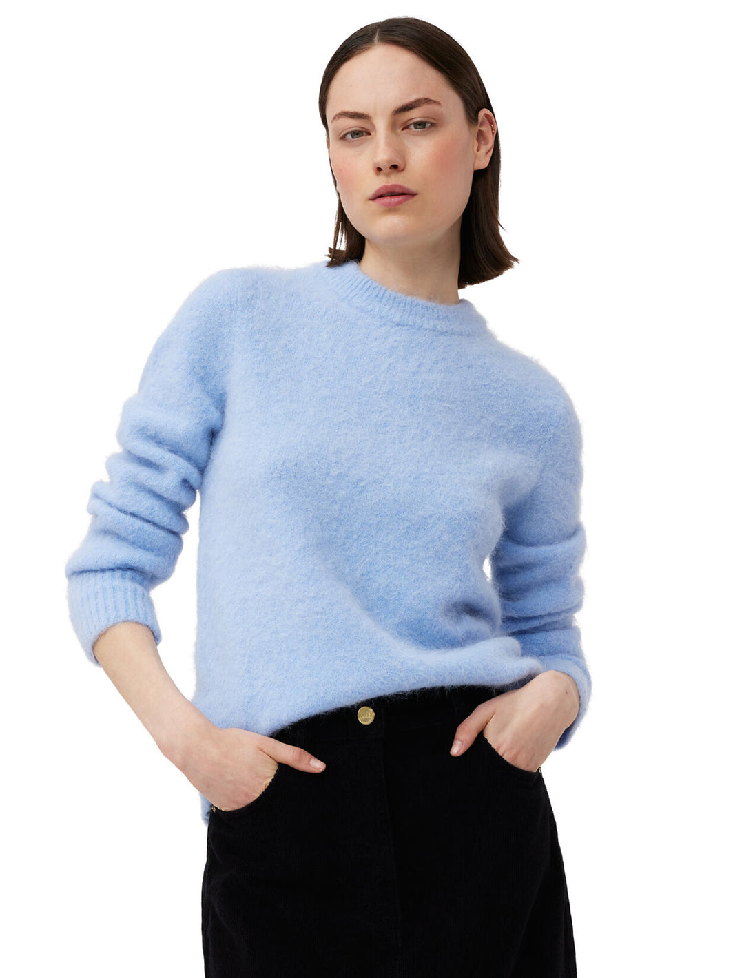 Model wearing GANNI's brushed alpaca o-neck pullover in powder blue.