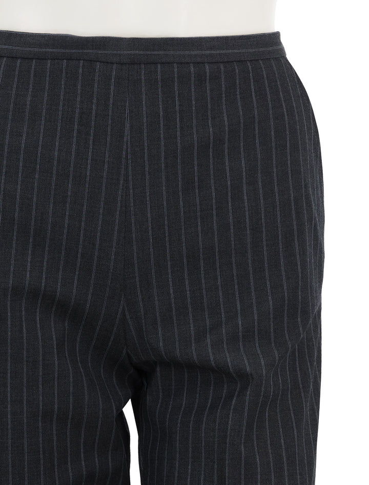 Close-up view of GANNI's stretch stripe mid waist pants.