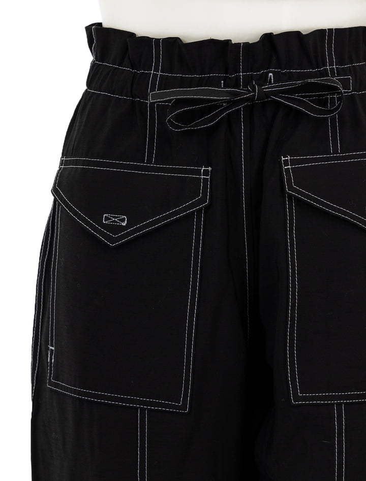 Close-up view of GANNI's light slub high waist pocket pants.
