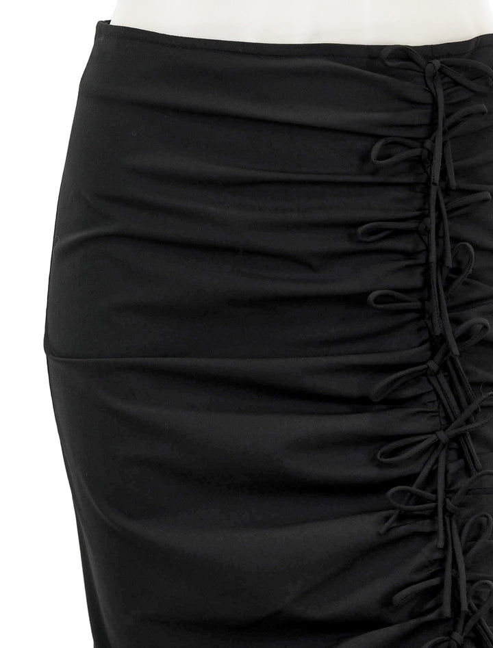 Close-up view of GANNI's drapey melange midi skirt.