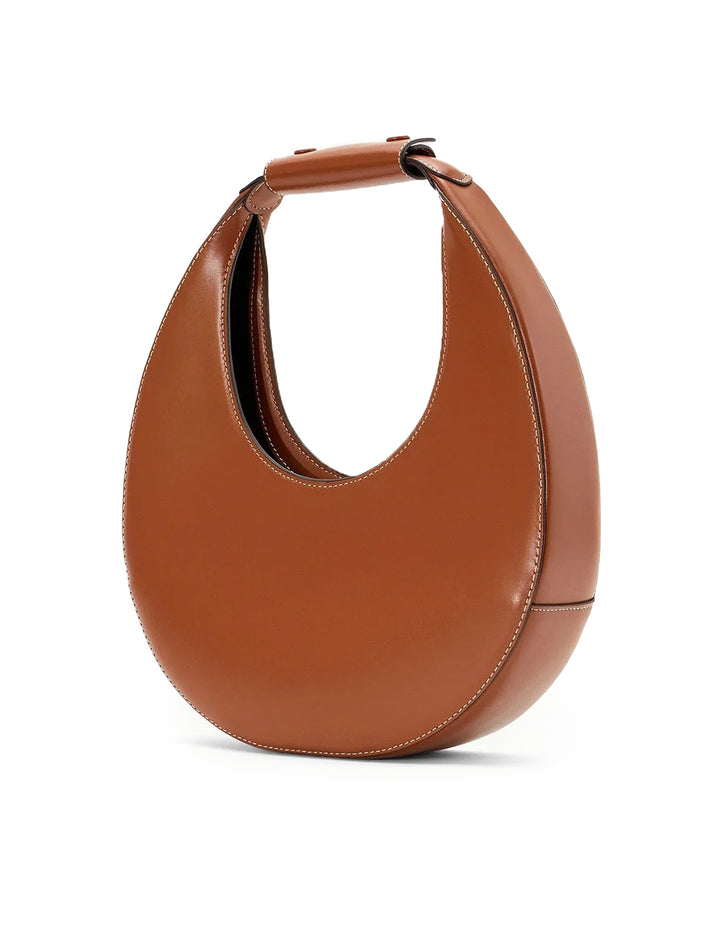 Side angle view of Staud's moon tote bag in tan.